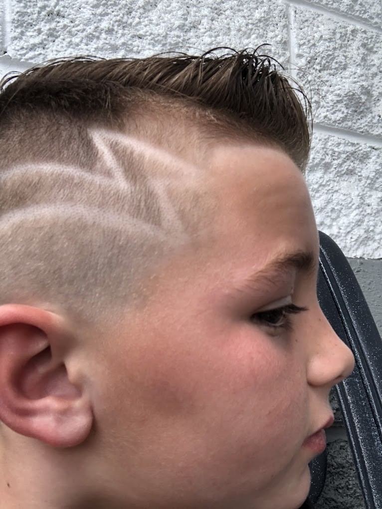 Detailed haircut design with a shaved lightning bolt pattern